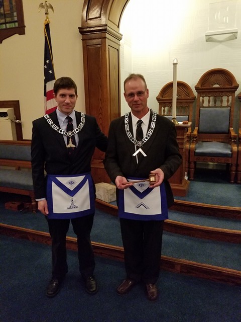 Past Master Jubinville presents current Master Ferguson a customized gavel